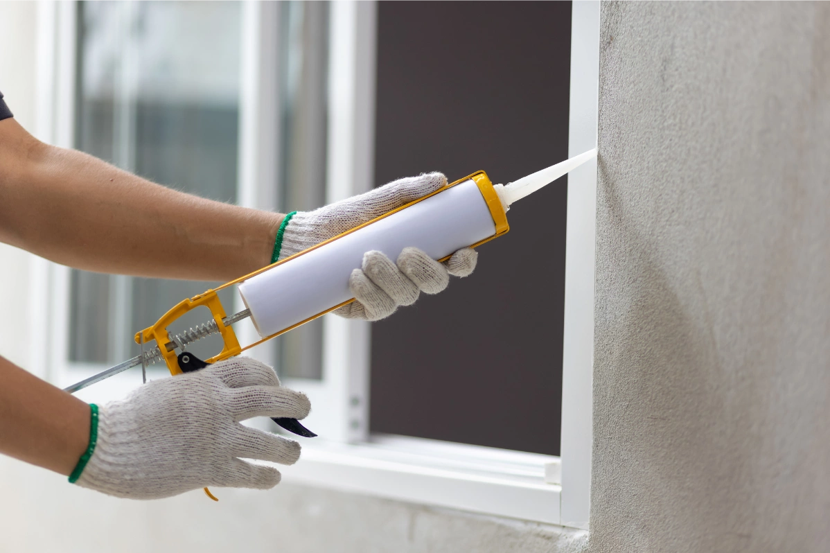 
Sealing gaps in window frame to prevent pests from getting in over summer